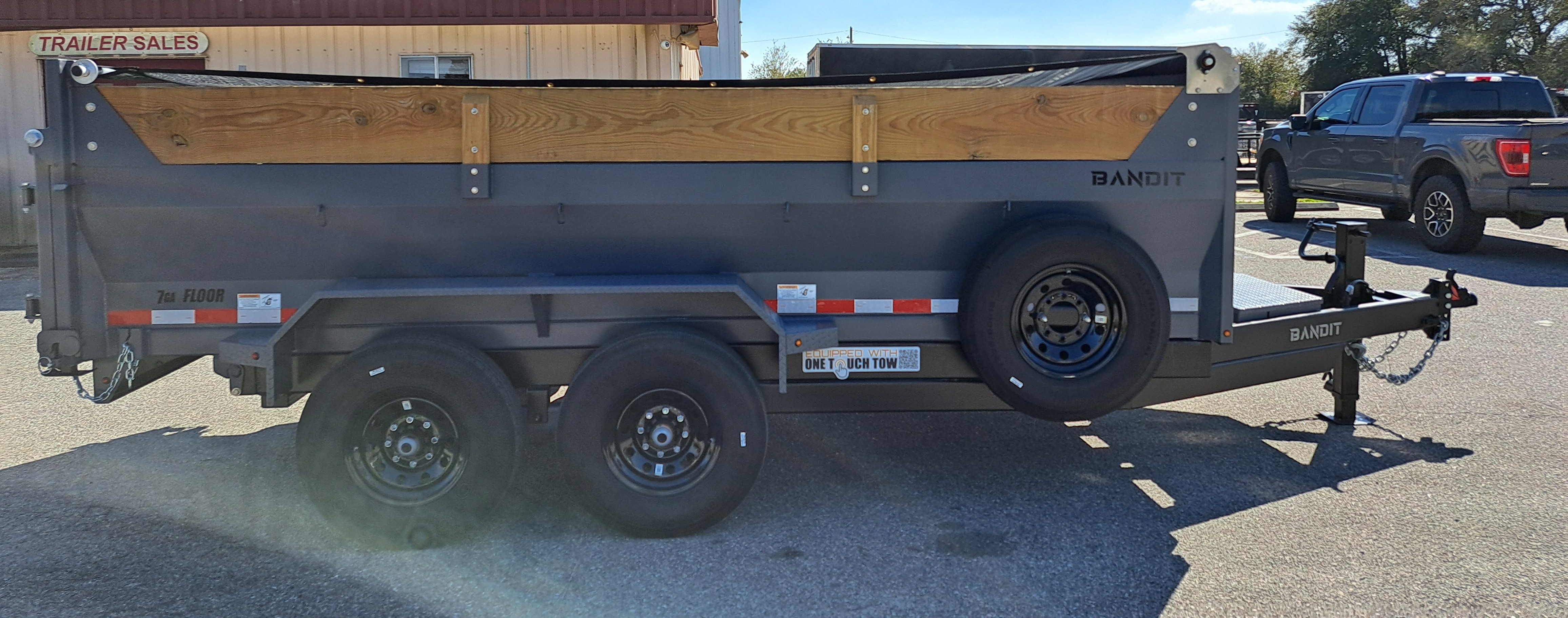 7x14 Bandit dump trailer side view at dealer
